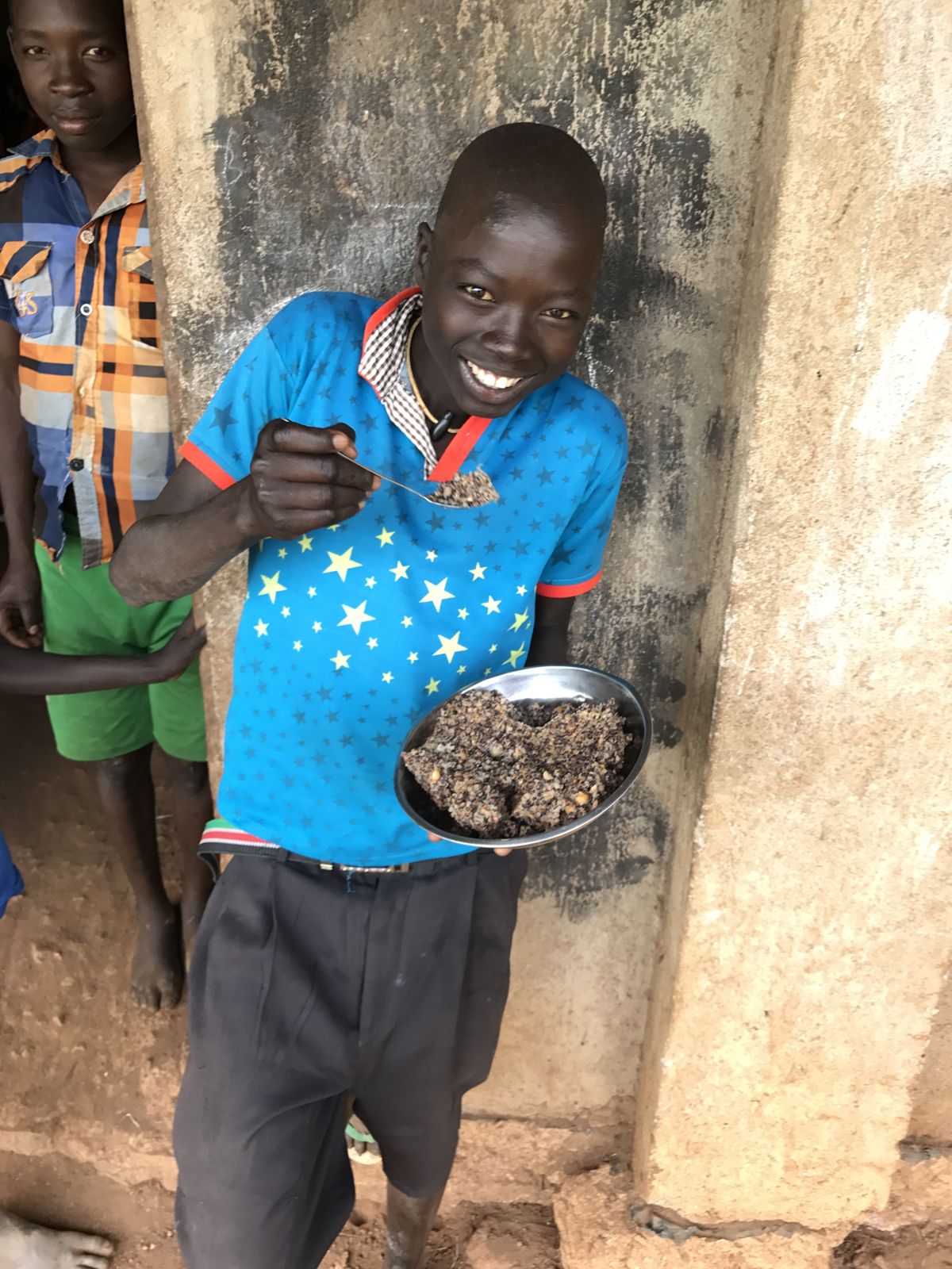 A student at the SEA Partners school holds up his lunch