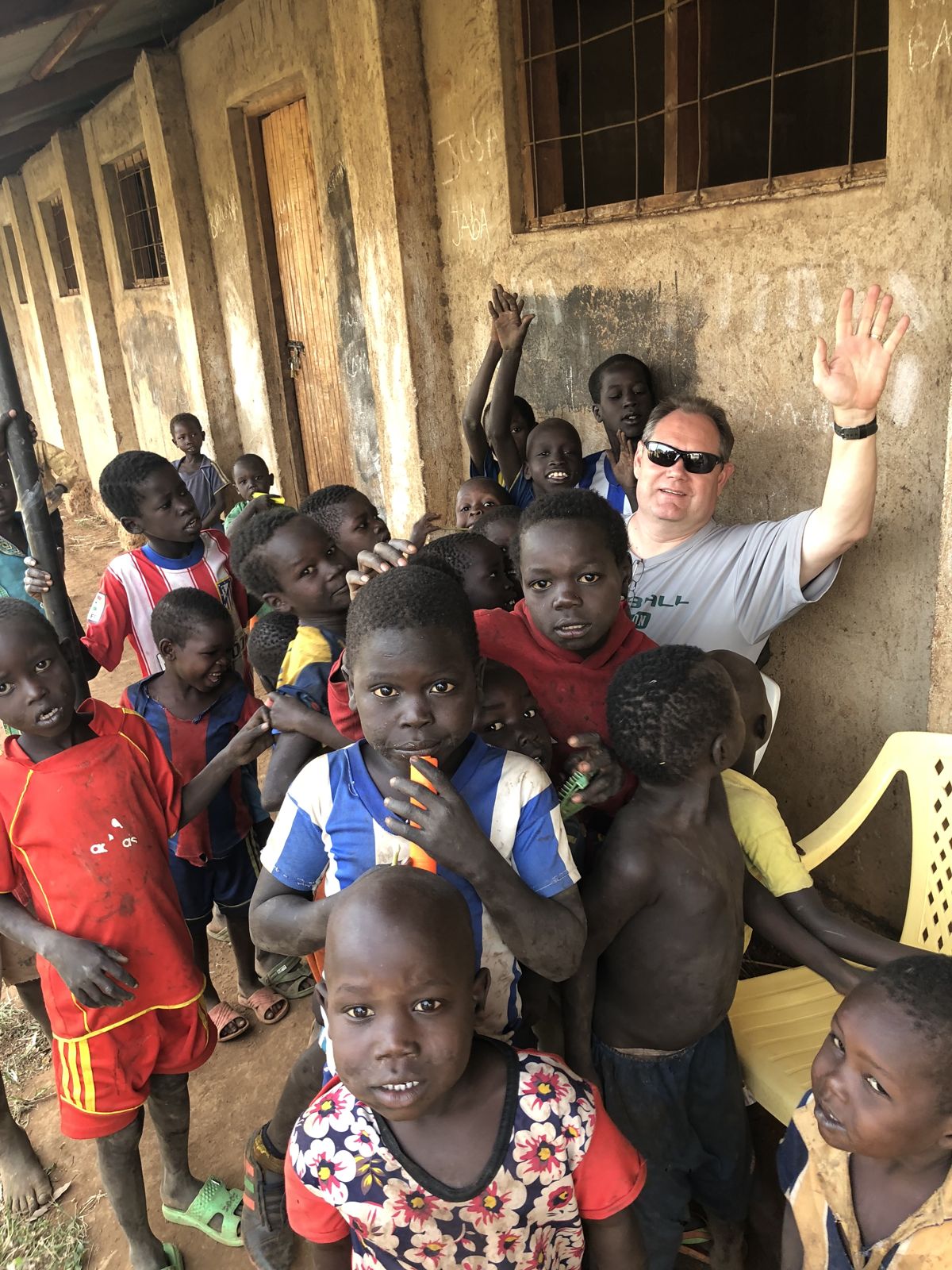 Donnie Brake waves among children at the school in Boma
